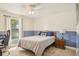 Comfortable bedroom with neutral carpeting, featuring a full size bed, window with bright natural light and an antique nightstand at 620 Fruitwood Ave, Winter Springs, FL 32708