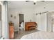 Serene bedroom with light gray walls, hardwood floors, and barn-style door leading to the bathroom at 620 Fruitwood Ave, Winter Springs, FL 32708