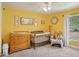 Bright Bedroom featuring a wooden crib, changing table, and charming decor, illuminated by a ceiling fan at 620 Fruitwood Ave, Winter Springs, FL 32708