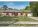 Charming brick ranch with manicured lawn, garage and lush landscaping providing lovely curb appeal at 620 Fruitwood Ave, Winter Springs, FL 32708