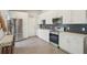 Modern kitchen with stainless steel appliances, white cabinets, and unique backsplash design at 620 Fruitwood Ave, Winter Springs, FL 32708