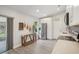 Bright kitchenette features stainless steel appliances, quartz countertops, and a sliding door to a screened-in patio at 620 Fruitwood Ave, Winter Springs, FL 32708