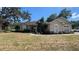 Charming home featuring tan stucco, arched windows, and a well-manicured lawn at 6438 Bristol Oaks Dr, Lakeland, FL 33811