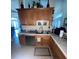 Functional kitchen with stainless steel sink and wooden cabinets providing ample storage at 6438 Bristol Oaks Dr, Lakeland, FL 33811