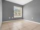 Bedroom with a large window that lets in natural light, tile flooring, and a view of the outdoors at 715 Wedge Ln, Poinciana, FL 34759