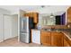 A practical kitchen features stainless steel refrigerator, a window above sink, and tile flooring at 715 Wedge Ln, Poinciana, FL 34759