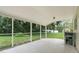 Relaxing screened porch overlooking a spacious backyard with mature trees and greenery at 715 Wedge Ln, Poinciana, FL 34759