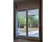 View of the backyard through sliding glass doors, revealing the landscaped yard at 7600 Skyview Dr, Orlando, FL 32809