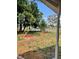 Landscaped front yard featuring mulched trees and green grass at 7600 Skyview Dr, Orlando, FL 32809