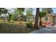 Exterior view of a home with fresh landscaping, trees, and a well-maintained lawn at 7600 Skyview Dr, Orlando, FL 32809