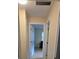 Hallway view with neutral walls and tile flooring leading to a bedroom at 7600 Skyview Dr, Orlando, FL 32809