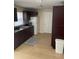 Eat-in kitchen features updated dark cabinetry, tile floor, and white appliances at 7600 Skyview Dr, Orlando, FL 32809