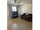 Comfortable living room with tile flooring, neutral walls, and a ceiling fan at 7600 Skyview Dr, Orlando, FL 32809