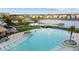 Aerial view of an expansive resort pool with sunbeds, lakeside views, and inviting relaxation spots at 8045 Lost Shaker Ln, Kissimmee, FL 34747