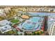 Aerial view showcasing the resort pool area and nearby splashpad surrounded by villas and lush landscaping at 8045 Lost Shaker Ln, Kissimmee, FL 34747