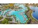 Stunning aerial view of the resort-style pool with cabanas, palm trees, and lush landscaping at 8045 Lost Shaker Ln, Kissimmee, FL 34747