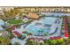 Overhead shot of the community showcasing a pool, playground, and colorful resort homes near a lake at 8045 Lost Shaker Ln, Kissimmee, FL 34747