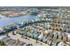 Aerial view showcasing colorful cottages in a lakeside community with pools at 8045 Lost Shaker Ln, Kissimmee, FL 34747
