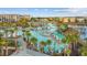 Stunning aerial view of the resort's sprawling pool area with cabanas, lush landscaping, and a tranquil lake at 8045 Lost Shaker Ln, Kissimmee, FL 34747