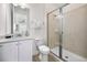 Bathroom featuring a glass-enclosed shower, white vanity, and tile flooring at 8045 Lost Shaker Ln, Kissimmee, FL 34747