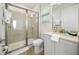 Bright bathroom features a glass enclosed shower, tile flooring, and a white vanity with marble countertop at 8045 Lost Shaker Ln, Kissimmee, FL 34747