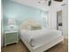 Bright bedroom featuring a white bed, cool-toned walls, natural light, closet space, and ceiling fan, creating a relaxing atmosphere at 8045 Lost Shaker Ln, Kissimmee, FL 34747