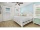 Inviting bedroom featuring a white bed, cool-toned walls, natural light, and ceiling fan, creating a relaxing and comfortable atmosphere at 8045 Lost Shaker Ln, Kissimmee, FL 34747