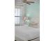Light and airy bedroom with a white bed, side tables, ceiling fan, and a large window at 8045 Lost Shaker Ln, Kissimmee, FL 34747