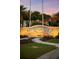 Illuminated Margaritaville Resort sign with palm trees, green lawns, and inviting landscaping at 8045 Lost Shaker Ln, Kissimmee, FL 34747