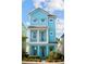 Charming three-story cottage with blue siding, white trim, and a welcoming front porch at 8045 Lost Shaker Ln, Kissimmee, FL 34747