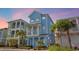 Charming three-story cottage with blue siding, white trim, and a welcoming front porch at 8045 Lost Shaker Ln, Kissimmee, FL 34747