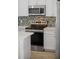 Close-up of the kitchen with stainless steel appliances, white cabinets, and a decorative tile backsplash at 8045 Lost Shaker Ln, Kissimmee, FL 34747
