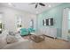 Bright living room features a comfortable sofa, stylish armchairs, and wood-look tile flooring at 8045 Lost Shaker Ln, Kissimmee, FL 34747