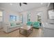 Cozy living room features a comfortable sofa, stylish armchairs, and wood-look tile flooring at 8045 Lost Shaker Ln, Kissimmee, FL 34747