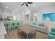 Open concept living room with ceiling fan, coastal decor, tile floors, and mint-colored dining set at 8045 Lost Shaker Ln, Kissimmee, FL 34747