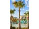 Lounge by the pool beneath swaying palms and vibrant blue umbrellas in this tropical resort at 8045 Lost Shaker Ln, Kissimmee, FL 34747