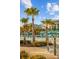 Lounge by the pool beneath swaying palms and vibrant blue umbrellas in this tropical resort at 8045 Lost Shaker Ln, Kissimmee, FL 34747