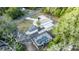 Aerial view of property showcasing house, pool, driveway, and landscaping at 817 Helen Ave, Deland, FL 32720