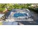 An aerial view shows the screened-in pool surrounded by a landscaped yard at 817 Helen Ave, Deland, FL 32720