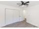 A bedroom with a ceiling fan, wood-look flooring, and a closet at 817 Helen Ave, Deland, FL 32720