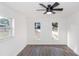 Bright bedroom featuring wood-look floors, a ceiling fan, and natural light from the multiple windows at 817 Helen Ave, Deland, FL 32720