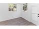 Bright bedroom with wood-look floors and natural light streaming through the windows and door to the exterior at 817 Helen Ave, Deland, FL 32720