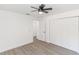 A bedroom with a ceiling fan, wood-look flooring, and a closet at 817 Helen Ave, Deland, FL 32720