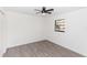 Well-lit bedroom featuring wood-look floors, ceiling fan, and a window providing plenty of natural light at 817 Helen Ave, Deland, FL 32720
