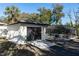 Detached garage with a dark door, well lit exterior lights, and a glimpse of the enclosed pool area at 817 Helen Ave, Deland, FL 32720