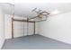 An empty garage featuring an overhead door, neutral color scheme, and storage or work space at 817 Helen Ave, Deland, FL 32720