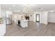 Open floorplan showcasing kitchen island, white cabinets, stainless steel appliances at 817 Helen Ave, Deland, FL 32720