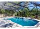 Screened-in pool surrounded by lush greenery offers a private oasis at 817 Helen Ave, Deland, FL 32720