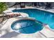 Inviting hot tub area with tiled accents inside a screened in pool enclosure at 817 Helen Ave, Deland, FL 32720