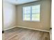 Bedroom with a window, and wood look flooring at 860 N Orange Ave # 371, Orlando, FL 32801